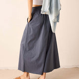 Navy blue pleated maxi skirt in a linen-blend fabric.