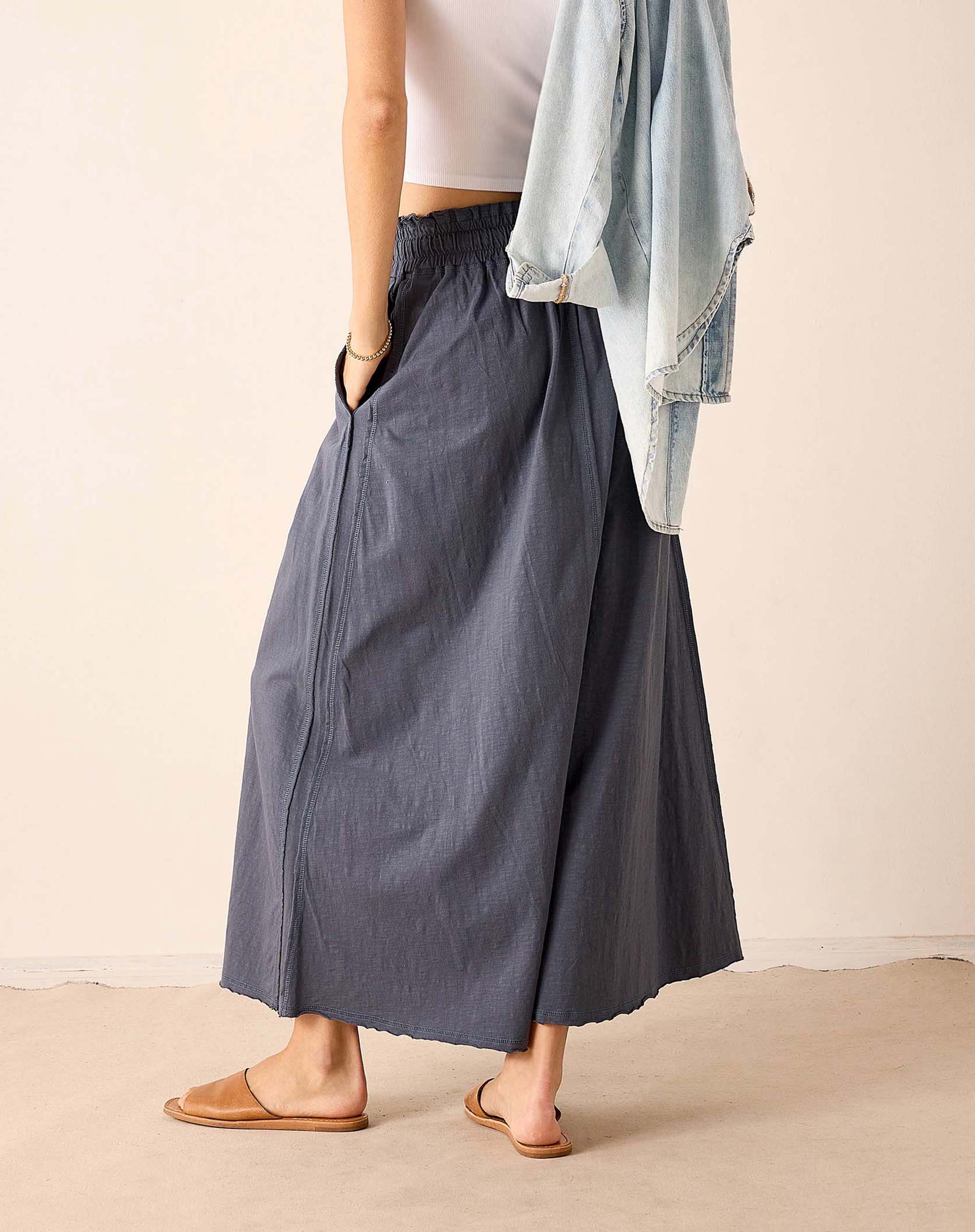 Navy blue pleated maxi skirt in a linen-blend fabric.