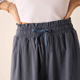 Navy blue linen blend skirt with a gathered elastic waistband and drawstring detail.