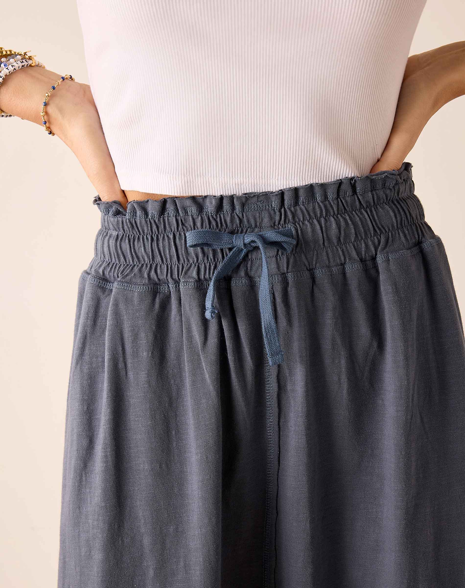 Navy blue linen blend skirt with a gathered elastic waistband and drawstring detail.