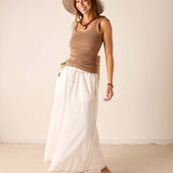 Ladies' travel-ready taupe ribbed cotton tank top paired with a white linen A-line skirt featuring a side slit.
