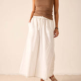 White linen-blend tiered skirt with a drawstring waist and wide hem.