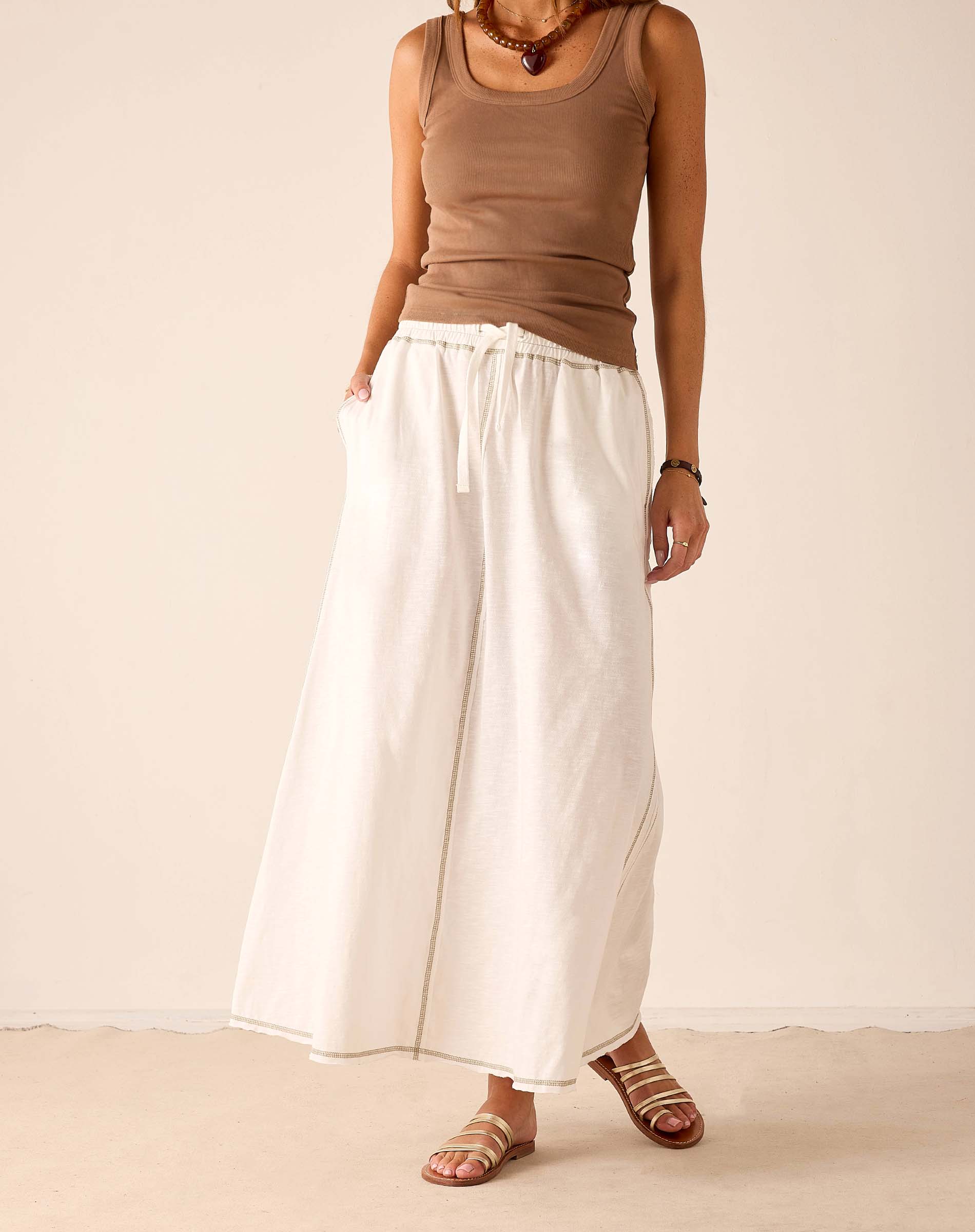 White linen-blend tiered skirt with a drawstring waist and wide hem.