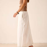 White linen-blend maxi skirt with a side slit and relaxed fit.