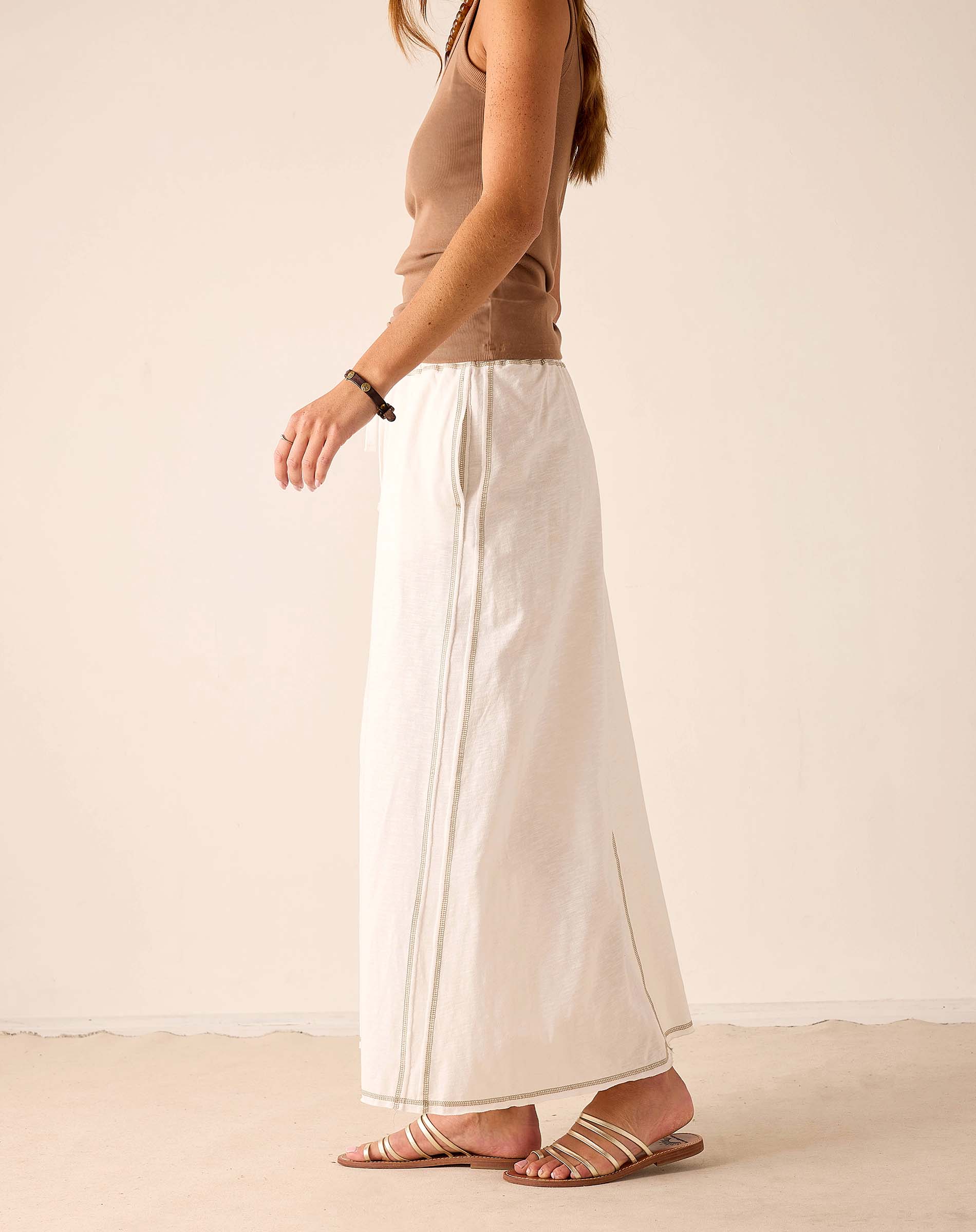 White linen-blend maxi skirt with a side slit and relaxed fit.