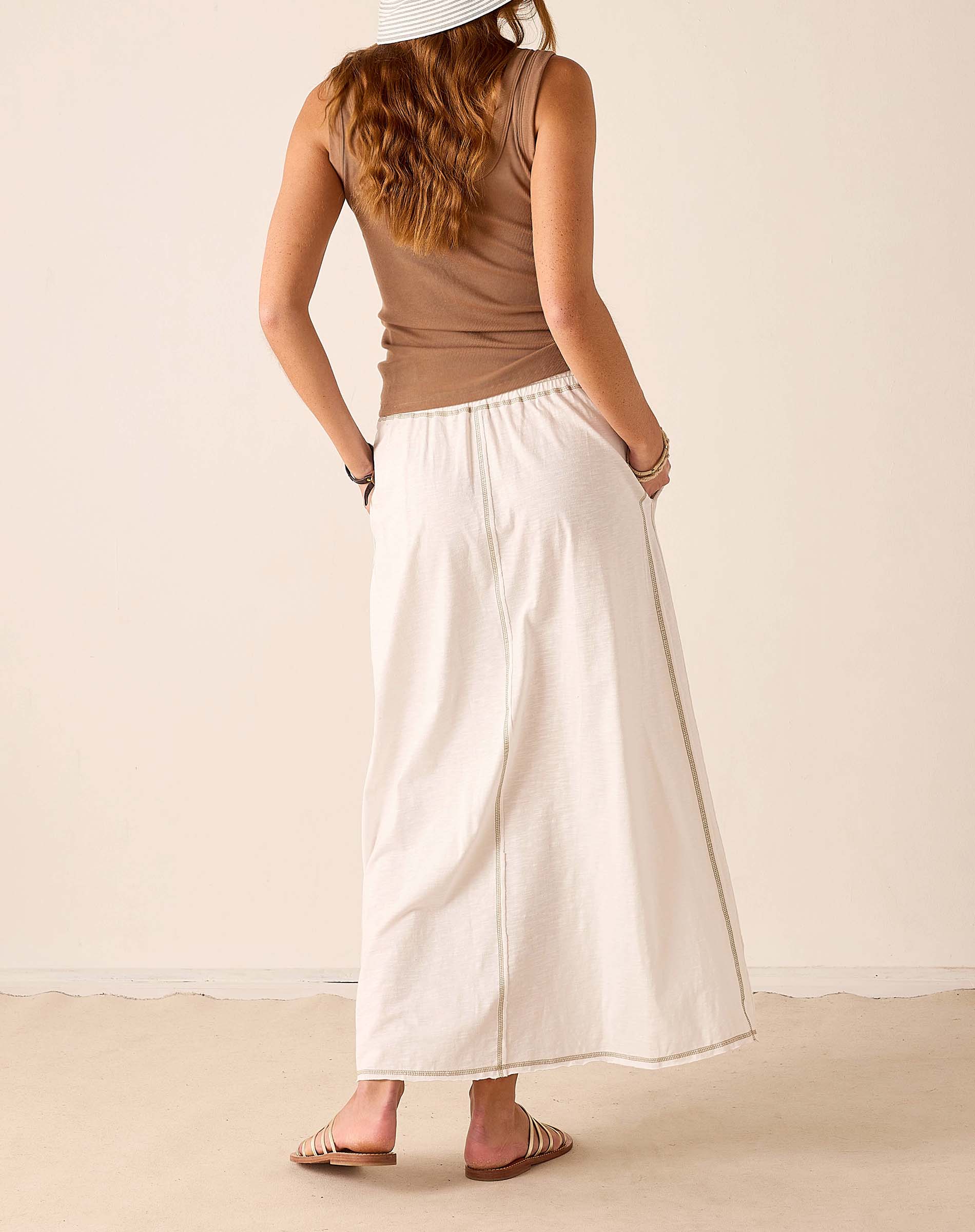 Back view of the white linen maxi skirt with a relaxed fit and side seam detail.