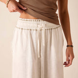 White relaxed fit linen-blend skirt featuring a drawstring waist and pleated front detail.