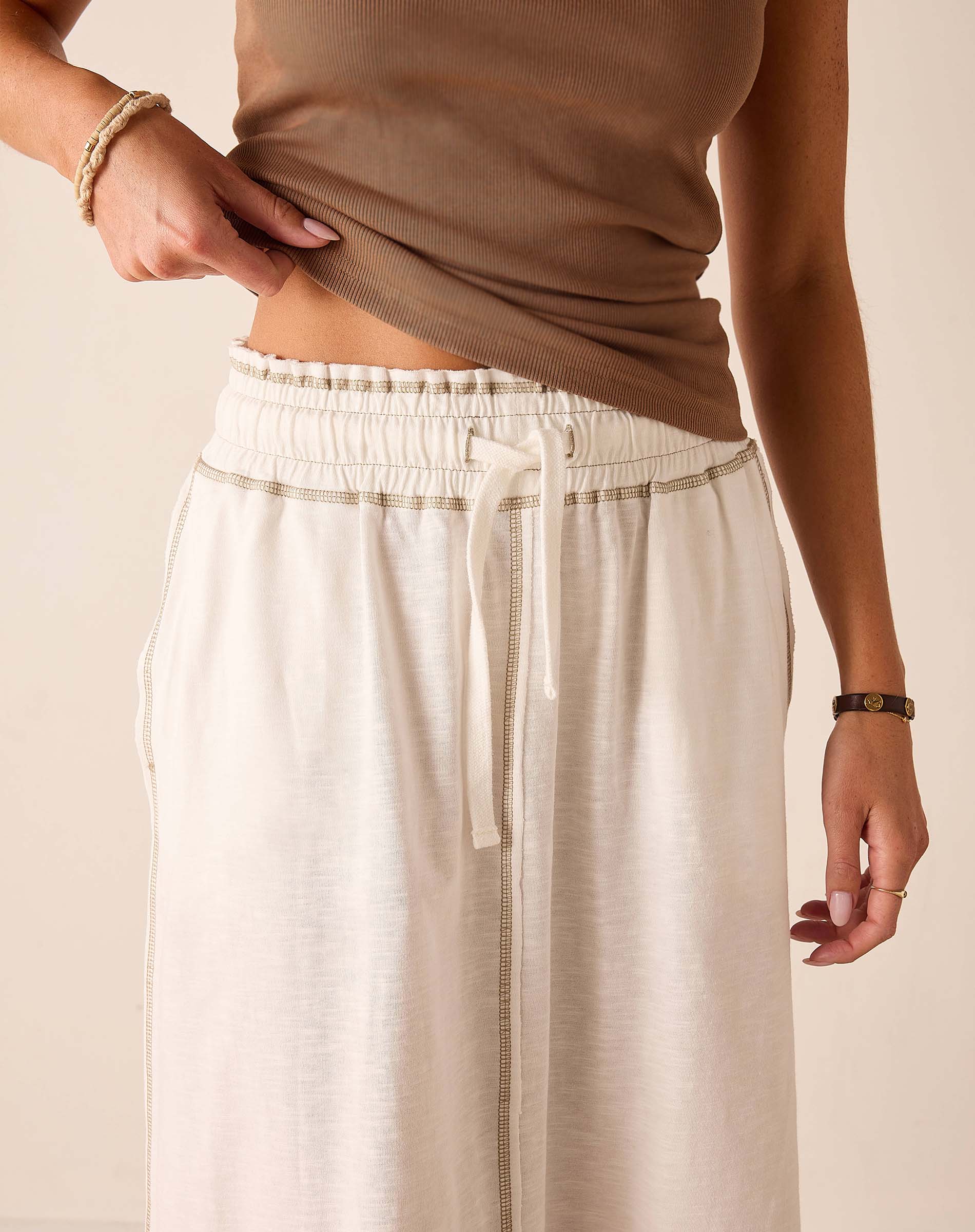 White relaxed fit linen-blend skirt featuring a drawstring waist and pleated front detail.