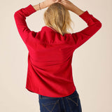 Back view of women's travel-friendly cardinal red tuxedo ruffle shirt