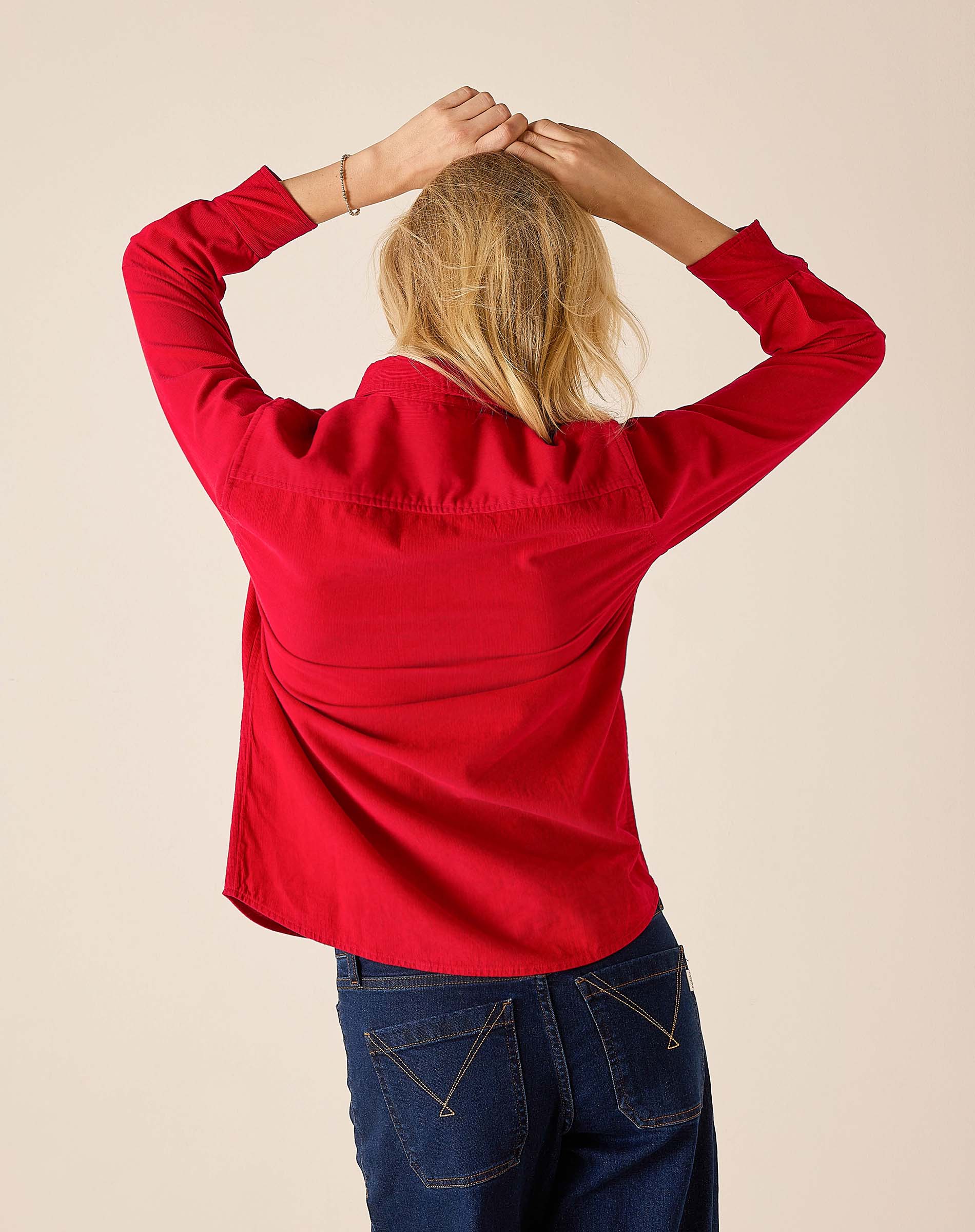 Back view of women's travel-friendly cardinal red tuxedo ruffle shirt