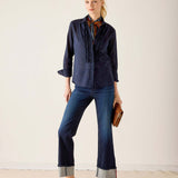 Women's travel-friendly navy blue tuxedo ruffle shirt with a button-up front and sheerer ruffled detailing on the bodice.