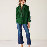 Ladies' travel-ready pine green tuxedo ruffle shirt with a button front and pleated detailing.