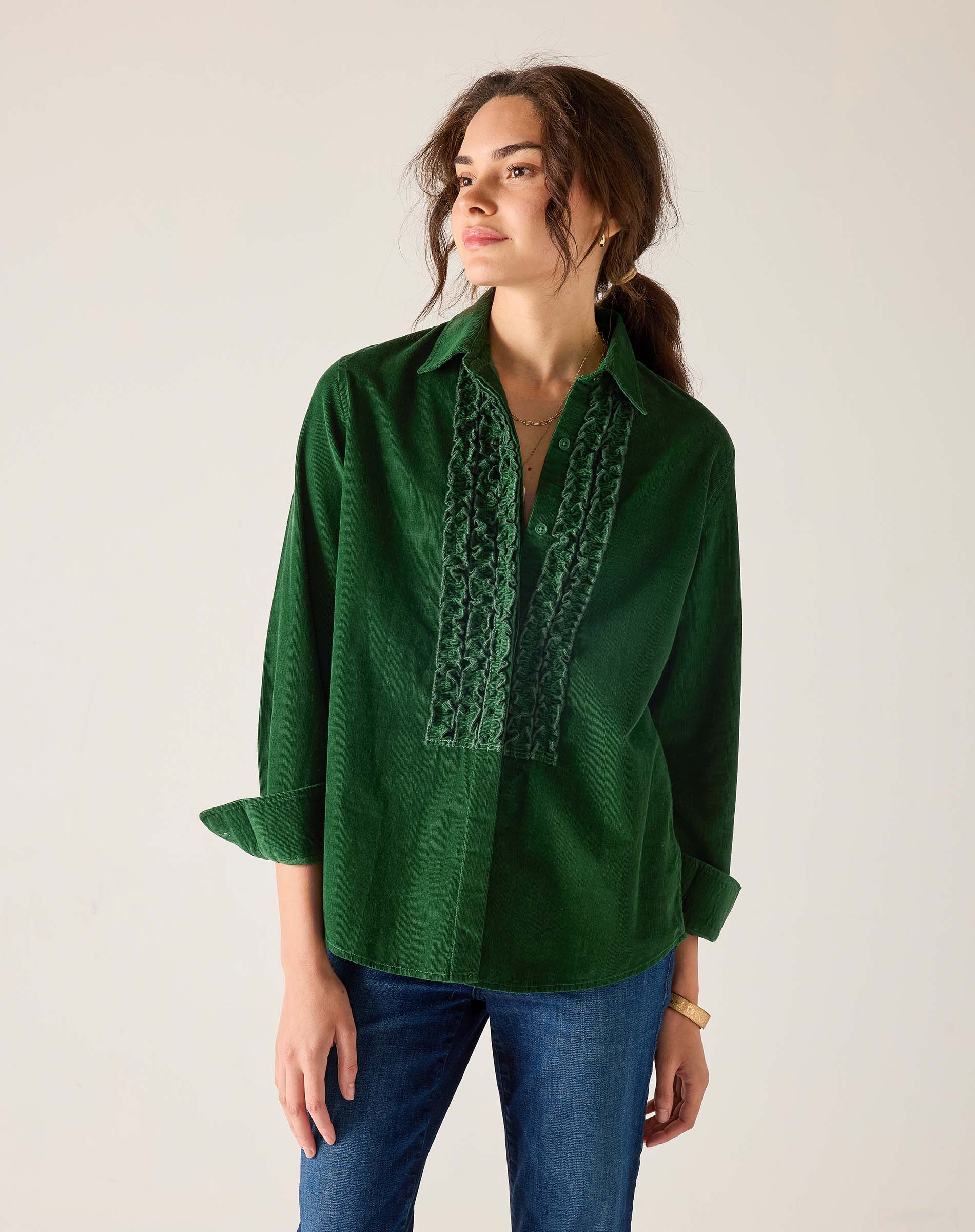 Pine green button-down shirt with ruffle details and long sleeves.