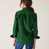 Back view of women's travel-friendly pine green tuxedo ruffle shirt in a soft cotton blend.