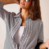 Ladies' travel-ready soft black pinstripe button-down shirt featuring decorative tuxedo-style ruffles and a collar.