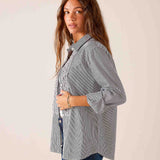 Soft black pinstriped button-down shirt featuring a feminine ruffled tuxedo front and tiered detail.