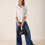 Women's travel-friendly white ruffled tuxedo shirt in cotton blend with eyelet details.