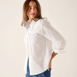 White oversized linen tuxedo ruffle shirt with buttons and pleated front detail.