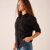 Black ruffle tuxedo top in a flowy fabric.