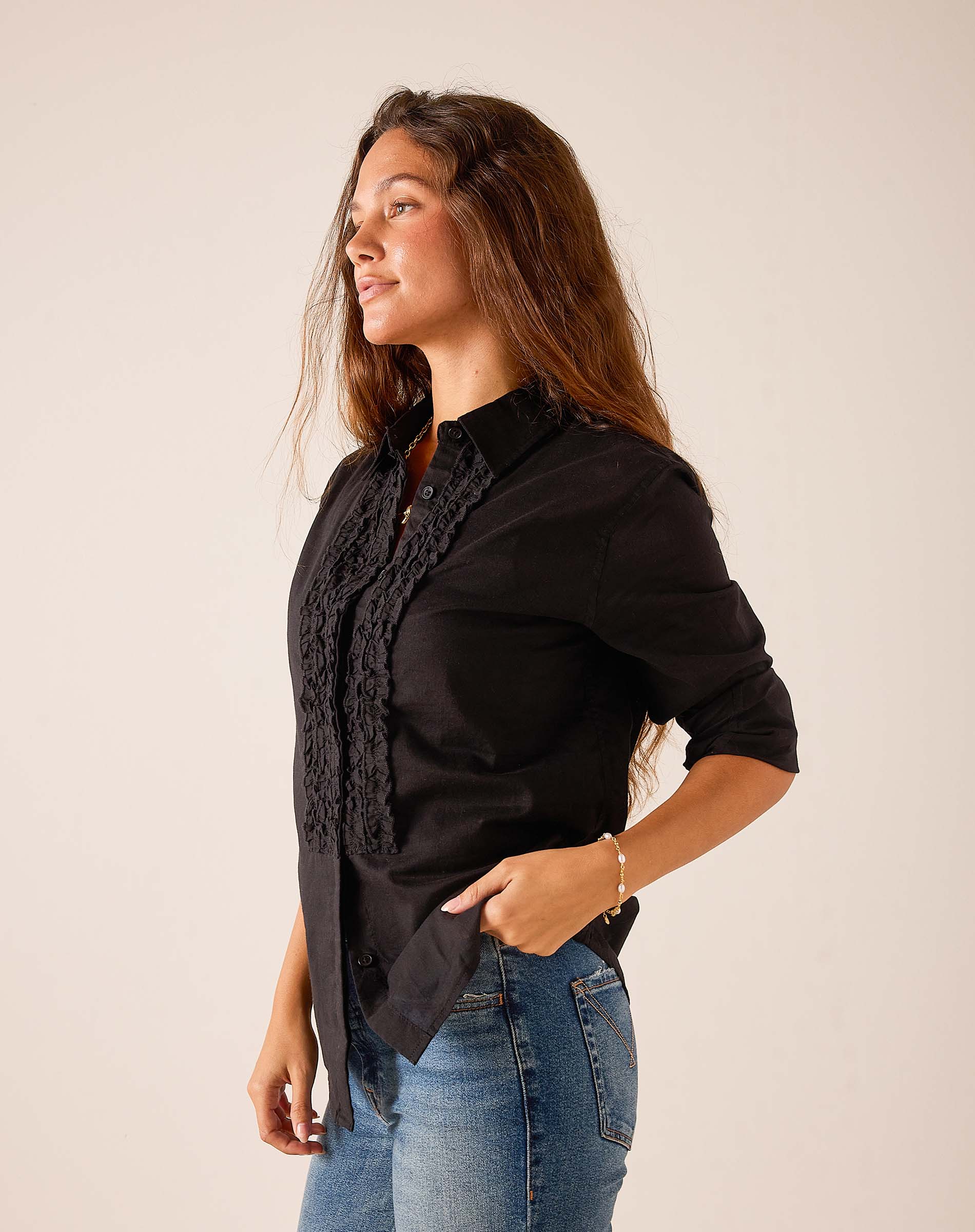 Black ruffle tuxedo top in a flowy fabric.