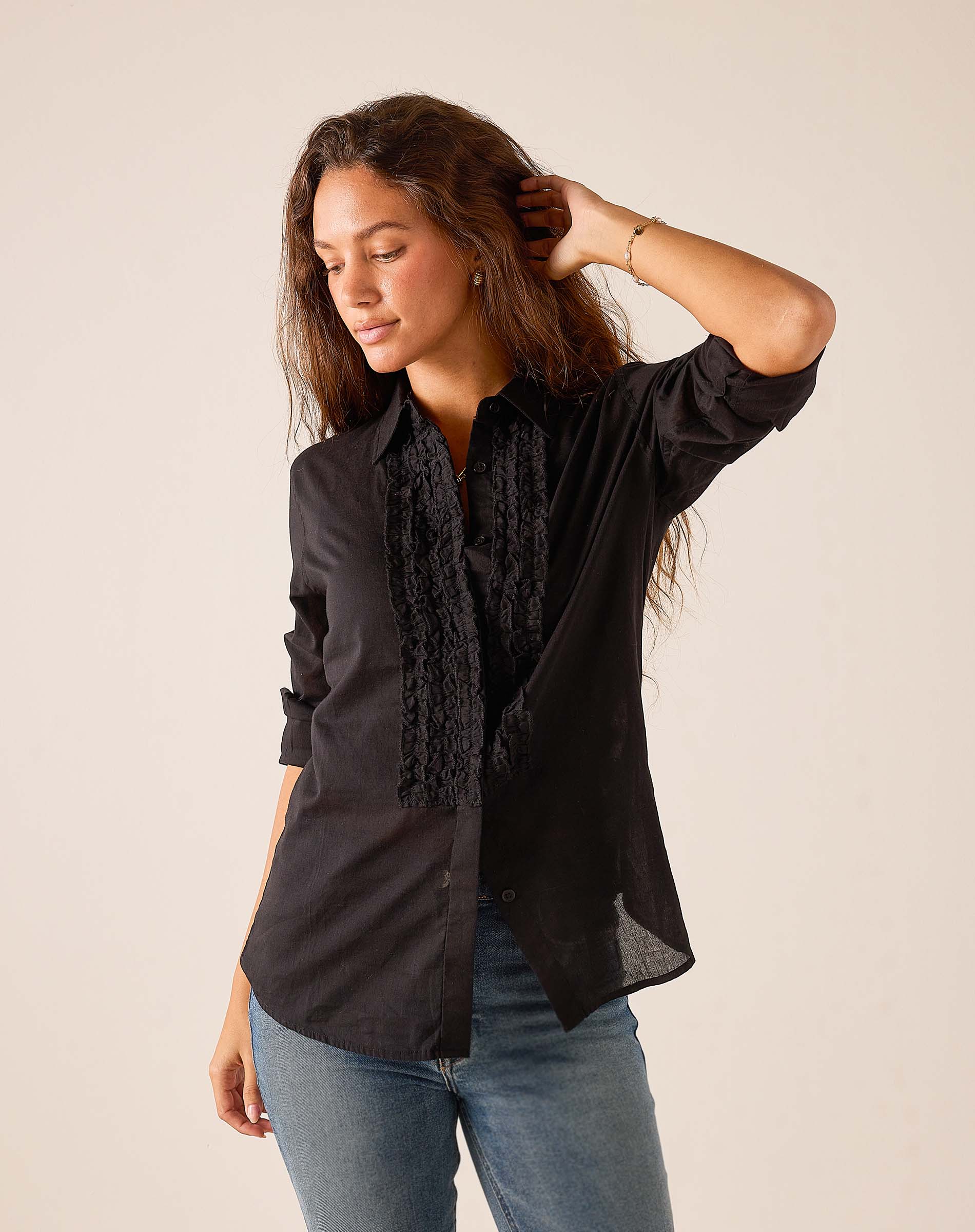 Black ruffle tuxedo top in soft cotton blend.