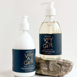 voyager shea lotion and hand soap laying on a white background