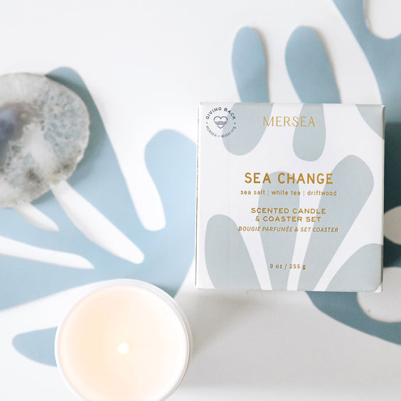 sea change candle in front of white and blue background