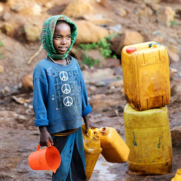 Child Collecting Drinking Water From Small Stream