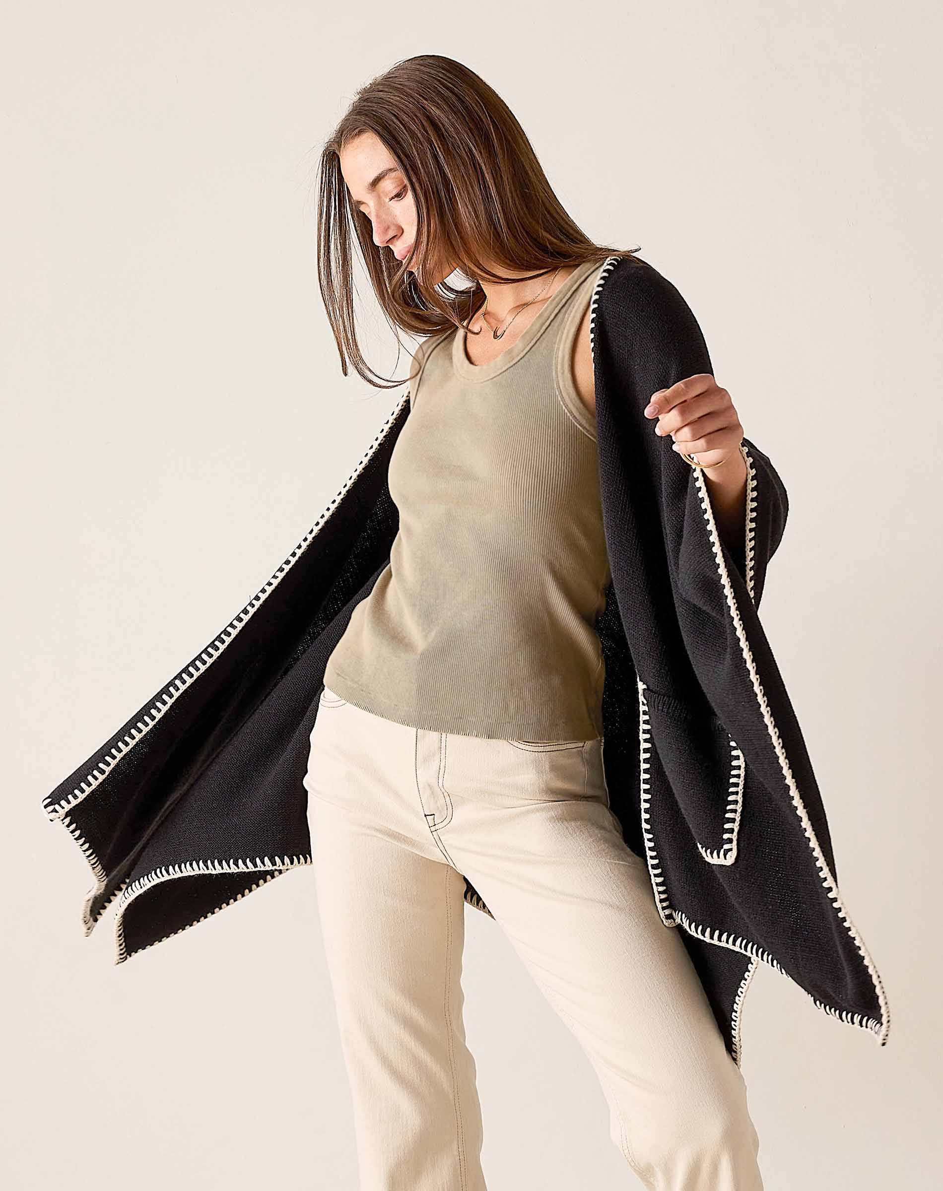 MERSEA ladies' travel-ready women's travel-friendly black and cream whipstitch travel wrap with a large rectangular drape.