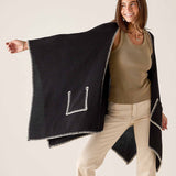 Black travel wrap with cream whipstitch trim and a stylized 'L' shape detail.