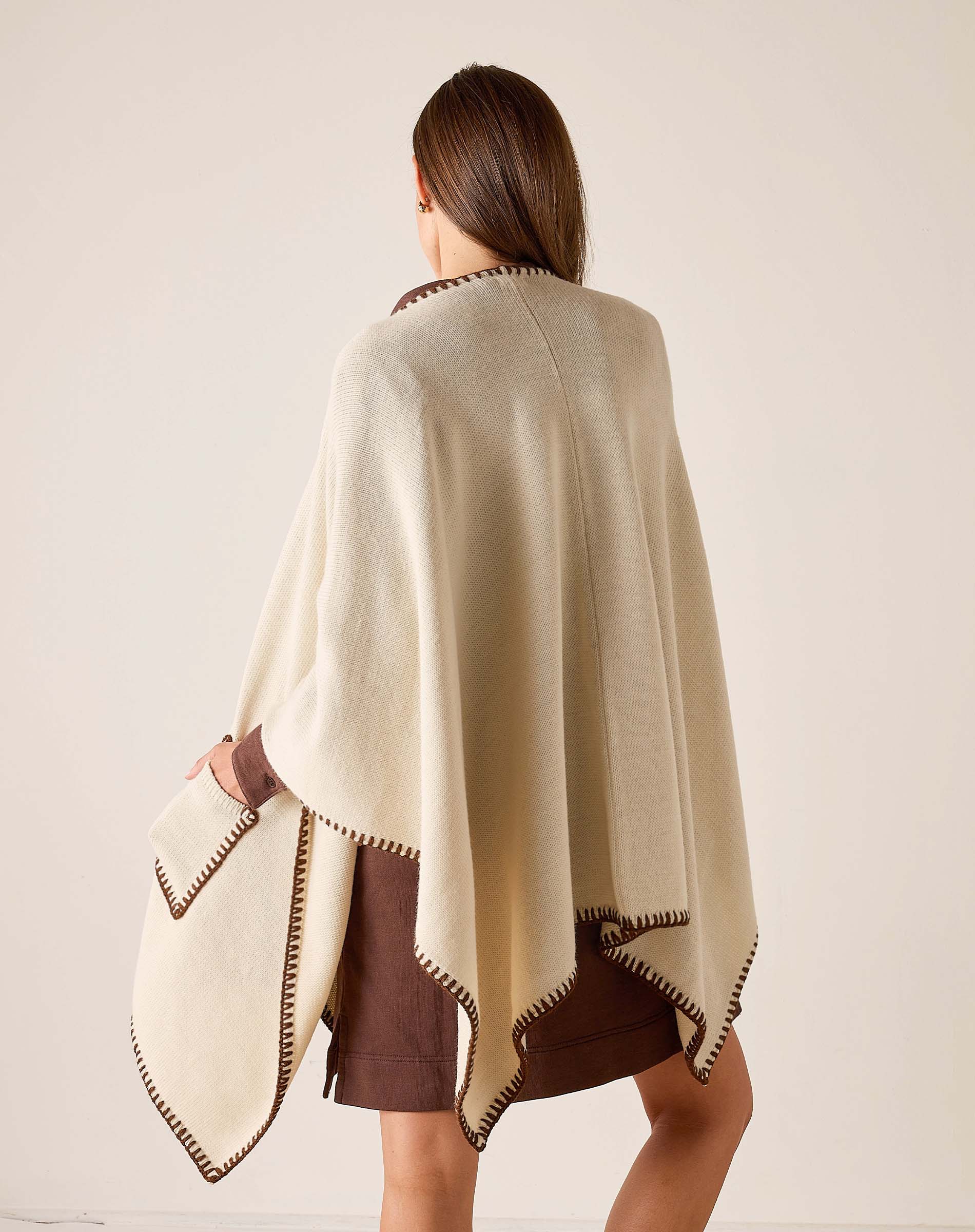 Back view of the cream wrap with bronze whipstitch detailing.