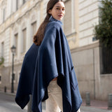 Navy whipstitch travel wrap in a cozy knit texture.