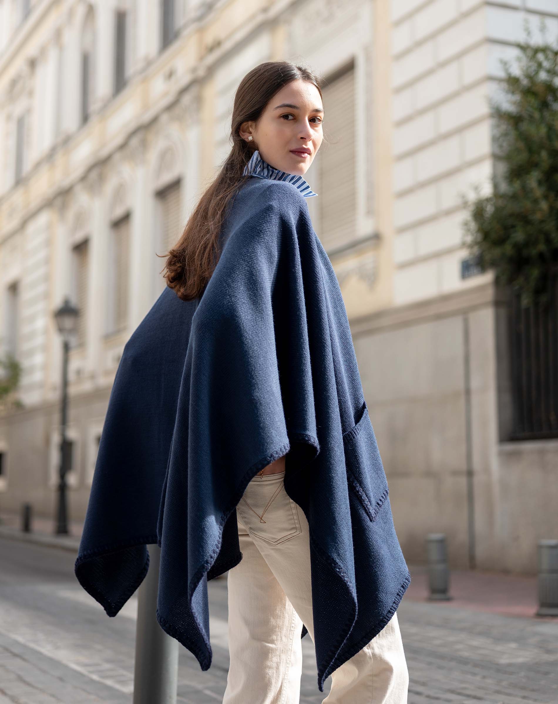 Navy whipstitch travel wrap in a cozy knit texture.