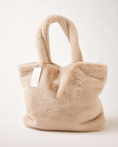 MERSEA women's travel-friendly beige faux fur tote bag with rounded handles and plush texture.