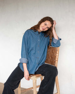 MERSEA ladies' travel-ready blue chambray button-up top with oversized cuffs and a relaxed fit.