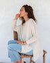 Women's Cream Crewneck Sweater with Brown Contrast Oversized Side View Sitting