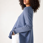 Woman wearing a blue sweater against a white background