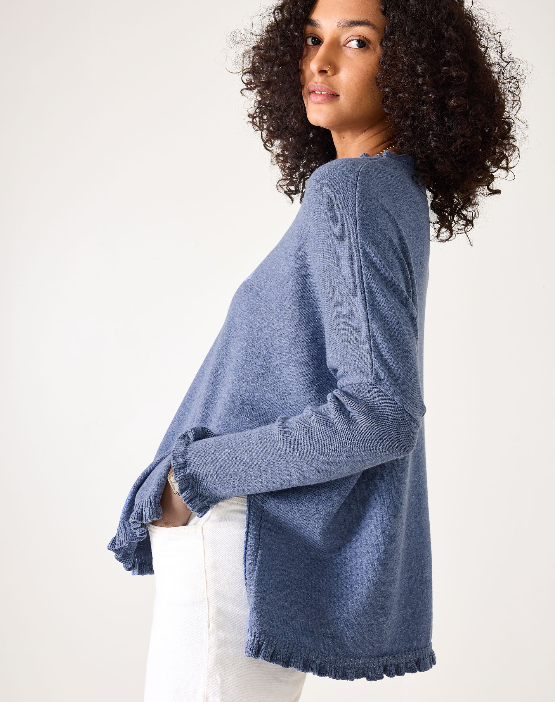 Woman wearing a blue sweater against a white background