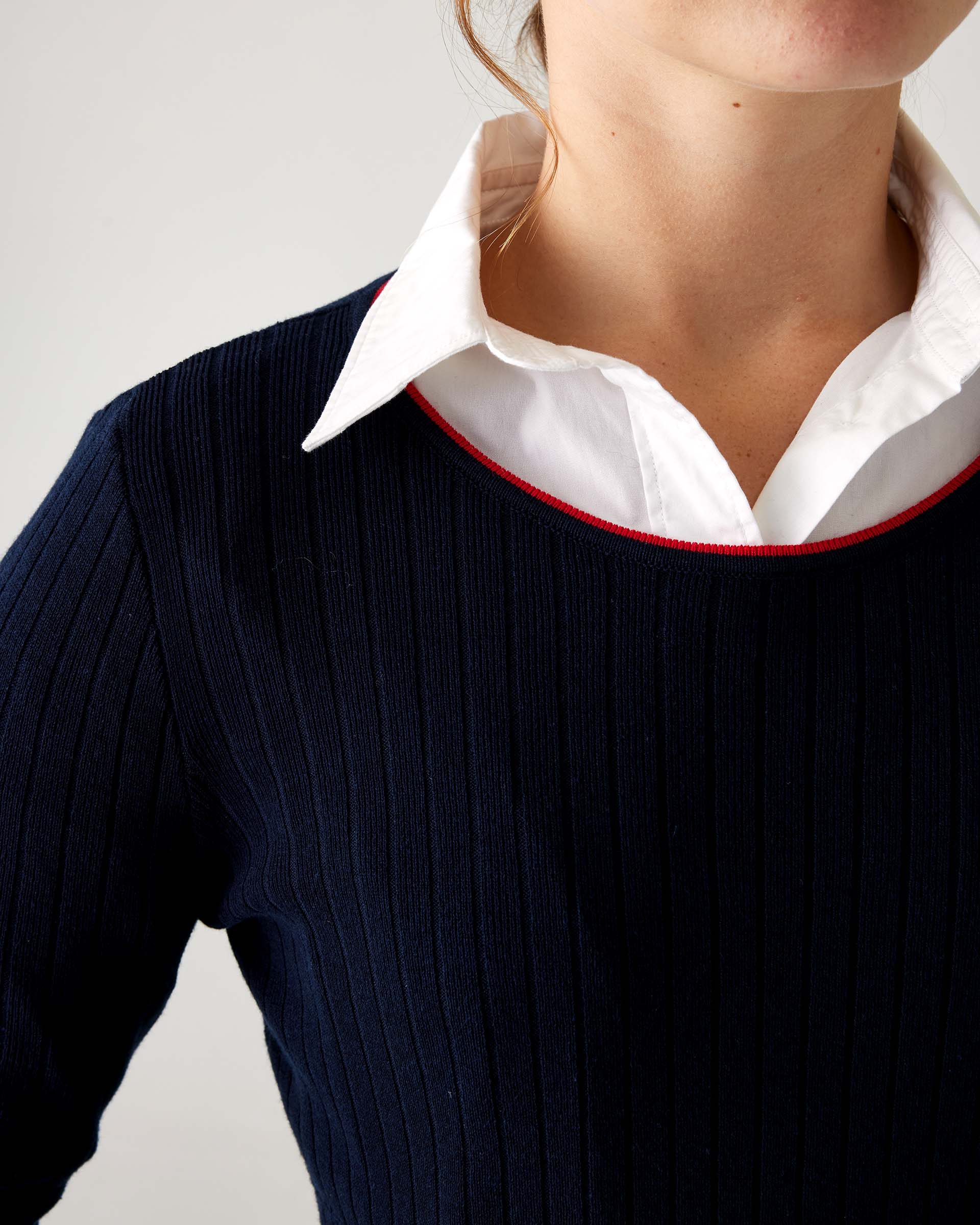 Women's Fall Autumn Navy Short Sleeve Rib Knit Peplum Waistline Sweater With Red Neckline Detail Closeup Crewneck
