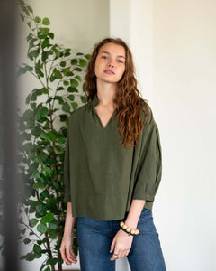 MERSEA ladies' travel-ready olive green relaxed-fit knit top with gathered cuffs and a V-neckline.