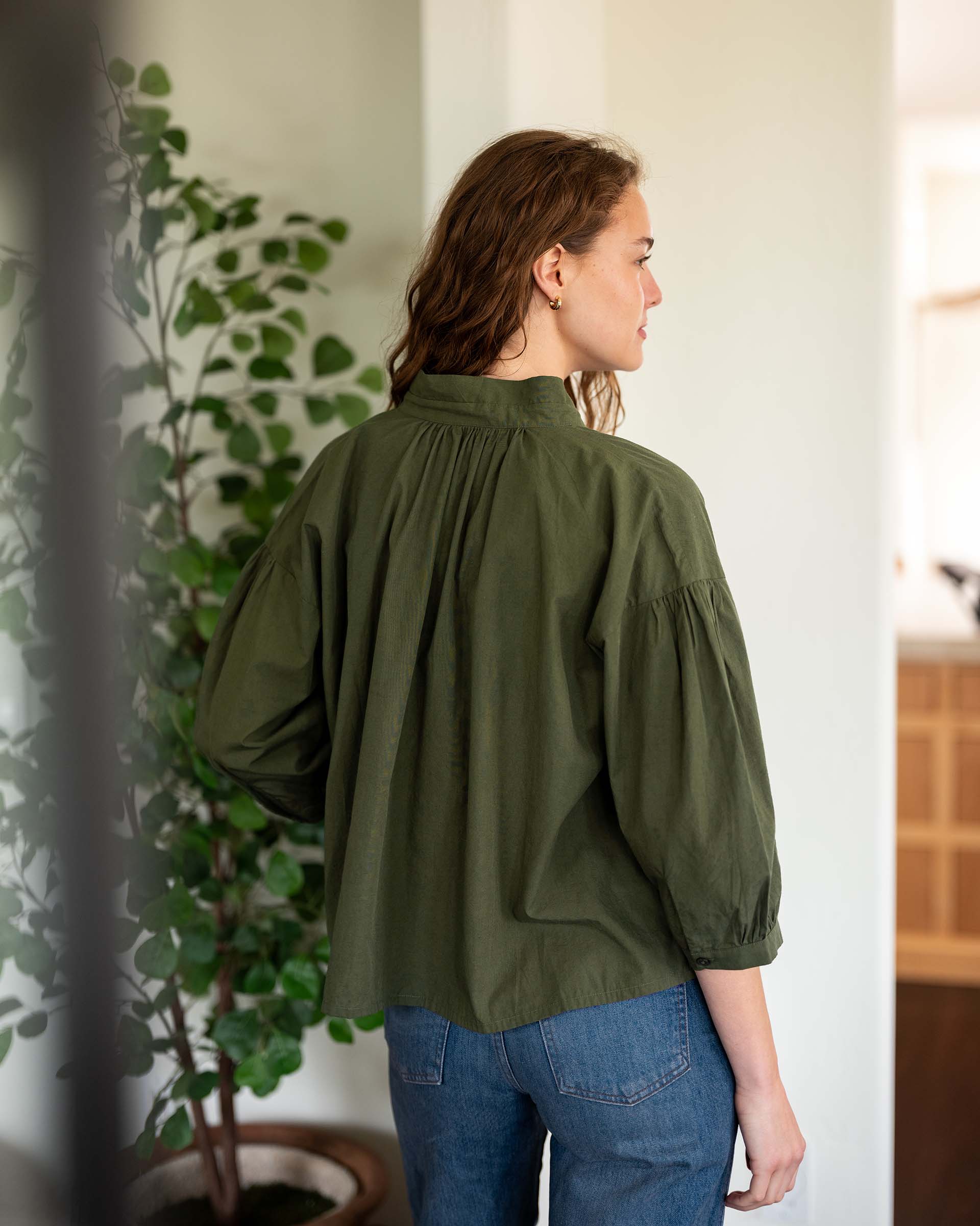 MERSEA women's travel-friendly travel-friendly rear view of women's olive green puff sleeve top with gathered stitching and a relaxed fit.