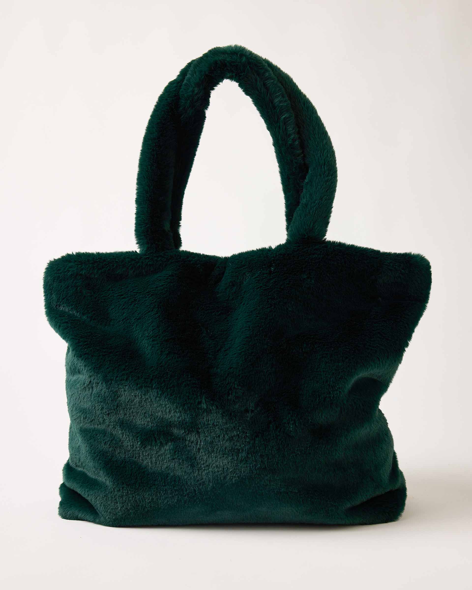 MERSEA women's travel-friendly emerald green faux fur tote bag with plush texture and top handles.
