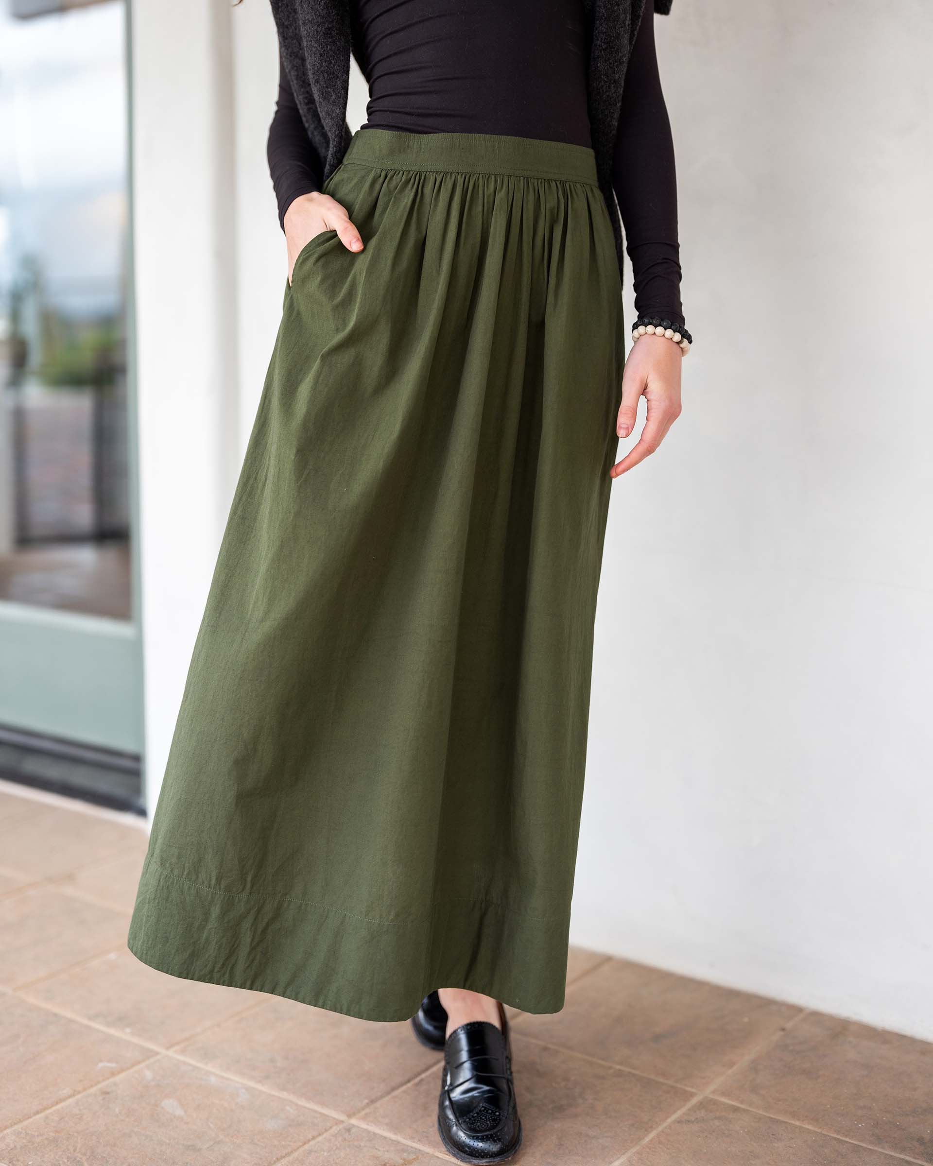 MERSEA ladies' travel-ready olive green maxi skirt with a gathered waist and front pockets.