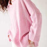 Women's Light Pink Midweight Loose Fitting V-neck Sweater Front View Leaning Forward Hands in Pockets