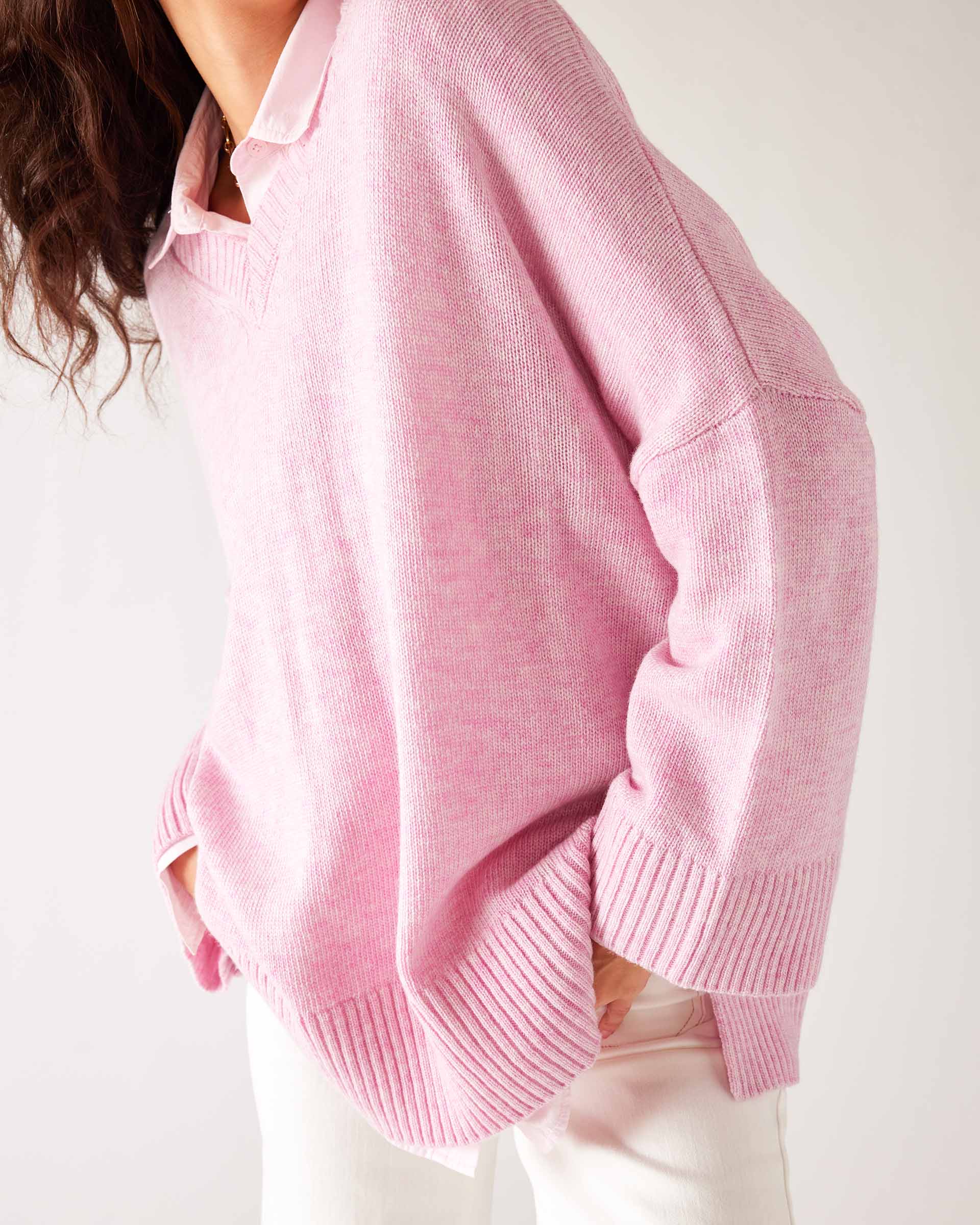 Women's Light Pink Midweight Loose Fitting V-neck Sweater Front View Leaning Forward Hands in Pockets