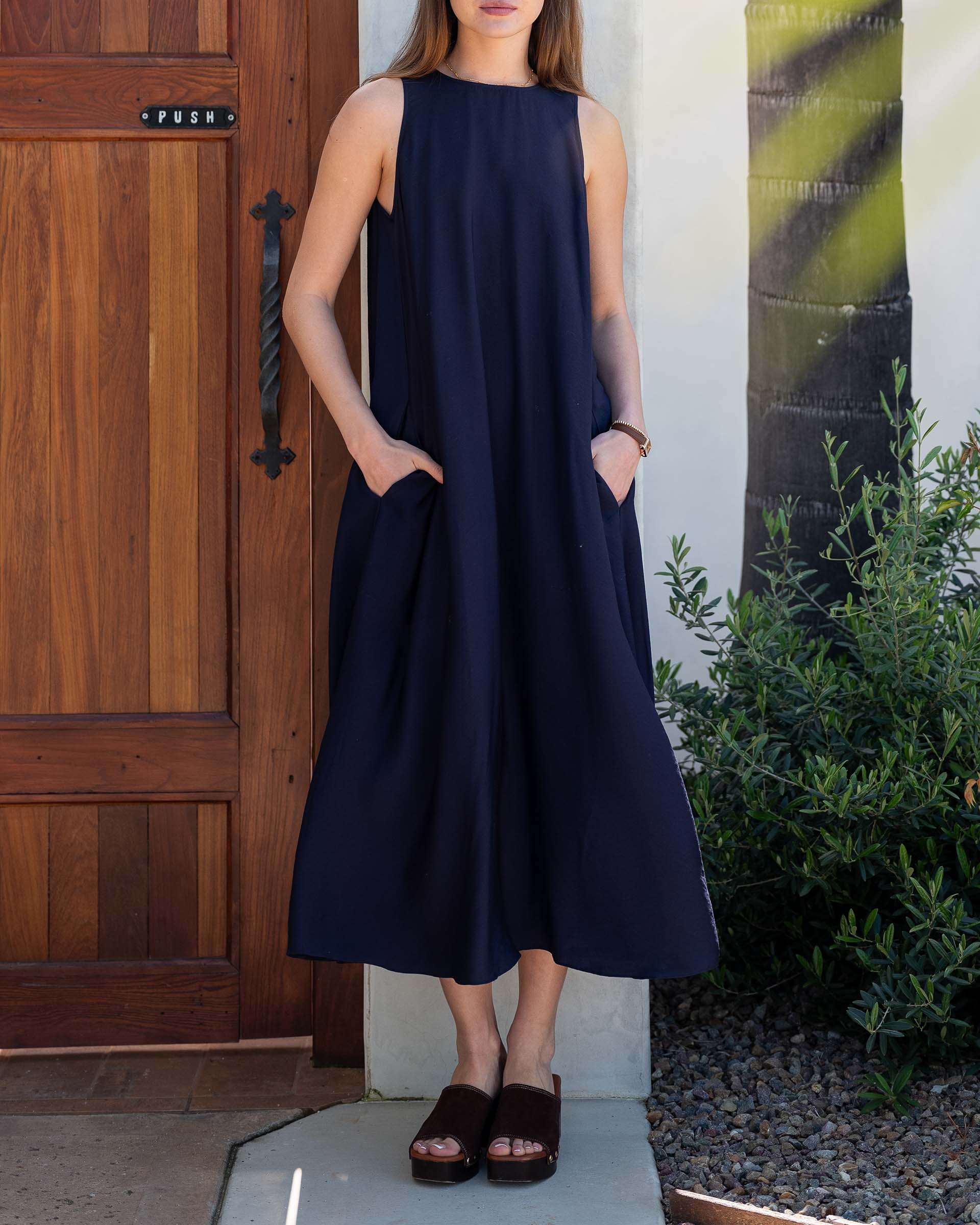 Women wearing Navy Maxi Dress with Pockets by a door