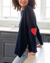 Women's One Size Navy Sweater with Red Hearts On Sleeve Side View in Home