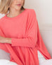 Women's Oversized Crewneck Knit Sweater in Coral Pink Chest View of Side Slits Sitting