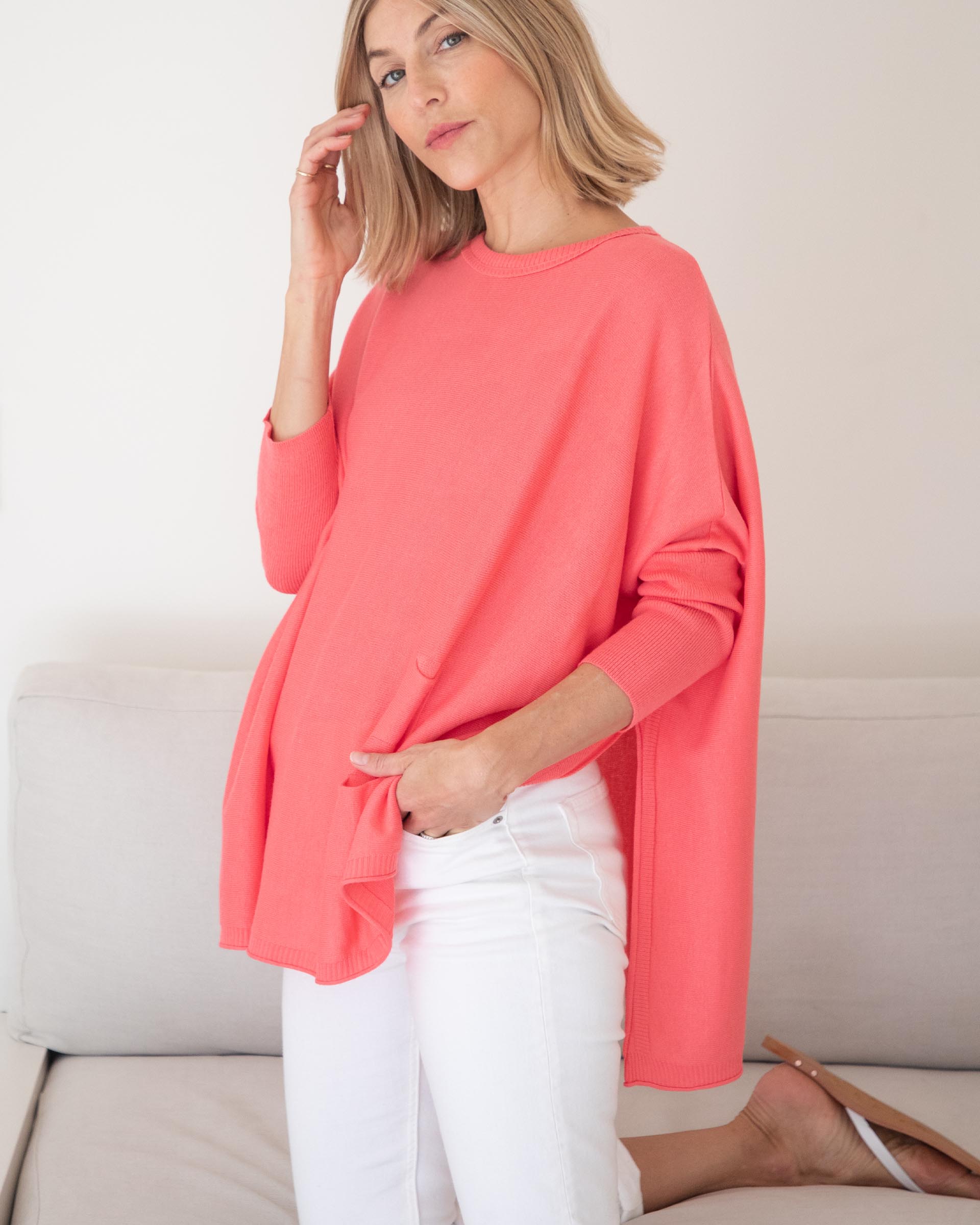 Women's Oversized Crewneck Knit Sweater in Coral Pink Side View of Side Slits