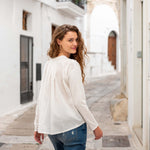 Women's White Front Pocket Pleated Back Crew Neck Long Sleeve Tee Rear View Travel Destination Looking Back Over Shoulder